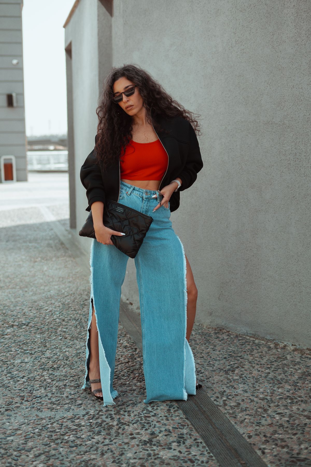 Woman in baggy jeans and a vintage-style graphic band t-shirt